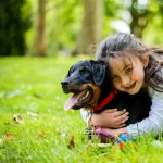 girl hugging a dog